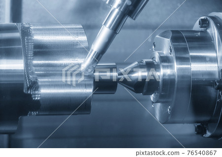The turn-mill machine cutting the metal cylinder shape. 76540867