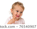 Little baby with finger inside mouth 76540907