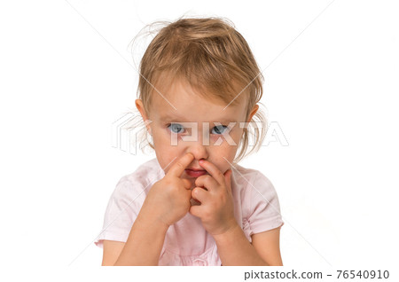 Baby girl is picking her nose with finger inside Baby girl is picking her nose with finger inside 76540910