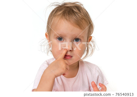 Baby girl is picking her nose with finger inside Baby girl is picking her nose with finger inside 76540913