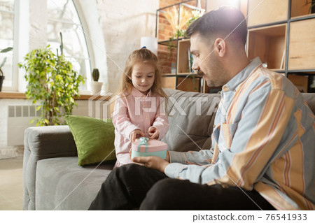 Happy father and little cute daughter at home. Family time, togehterness, parenting and happy childhood concept. Weekend with sincere emotions. Happy father and little cute daughter at home. Family time, togehterness, parenting and happy childhood concept. Weekend with sincere emotions. 76541933