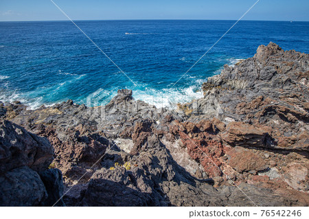 Crashing waves on volcanic coastline of Tenerife 76542246