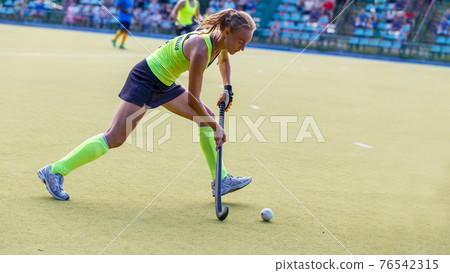 Field hockey woman player passes the ball Field hockey woman player passes the ball 76542315
