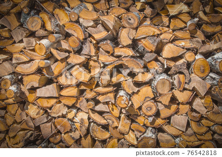 Chopped and stacked pile of pine and birch wood. Chopped and stacked pile of pine and birch wood. 76542818