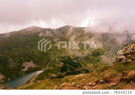 View from Mount Gutyn Tomnatyk to Lake Brebeneskul, a lake in the valley of the Carpathian Mountains, the highest lake in Ukraine. 76543219