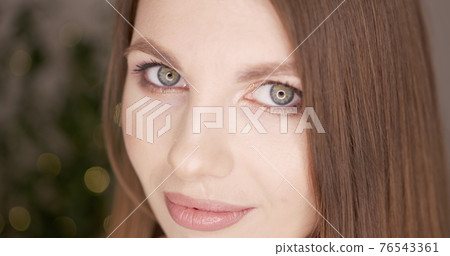 Beauty woman face with green eyes looking at camera. Skin care treatment or cosmetic ads concept. Beautiful female model with perfect fresh and clean skin. Nude make-up. In studio. Beauty woman face with green eyes looking at camera. Skin care treatment or cosmetic ads concept. Beautiful female model with perfect fresh and clean skin. Nude make-up. In studio. 76543361