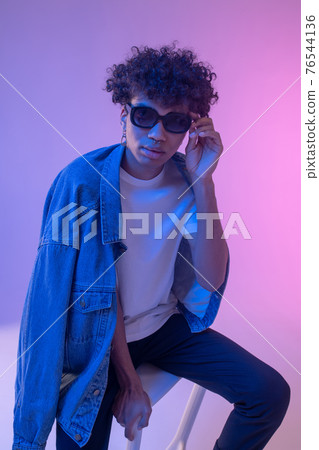 Stylish african american male model in denim jacket posing in studio 76544136
