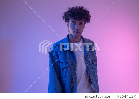 Stylish african american male model in denim jacket posing in studio 76544137