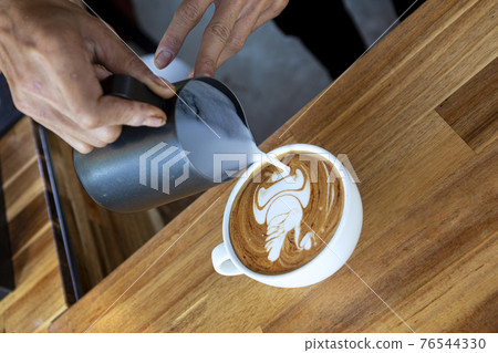 Art Coffee in White Cup on wood table in coffee shop. 76544330
