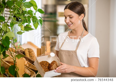 Delighting long haired woman with packed buns Delighting long haired woman with packed buns 76544348