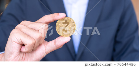 Businessman hand holding golden ZCASH (ZEC) cryptocurrency coin, Crypto is Digital Money within the blockchain network, is exchanged using technology and online internet exchange. Financial concept Businessman hand holding golden ZCASH (ZEC) cryptocurrency coin, Crypto is Digital Money within the blockchain network, is exchanged using technology and online internet exchange. Financial concept 76544486
