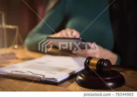 Lawyer business man working with paperwork on his desk in office workplace for consultant lawyer in office. Lawyer business man working with paperwork on his desk in office workplace for consultant lawyer in office. 76544905