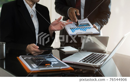 Business Corporate team brainstorming, Planning Strategy having a discussion Analysis investment researching with chart at office desk documents in office. Business Corporate team brainstorming, Planning Strategy having a discussion Analysis investment researching with chart at office desk documents in office. 76544906