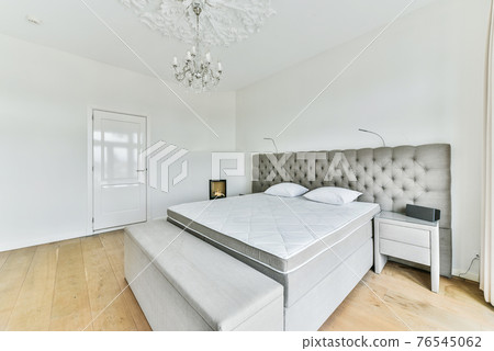 Comfortable bed in light bedroom Comfortable bed in light bedroom 76545062