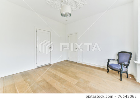 Elegant armchair in spacious room Elegant armchair in spacious room 76545065
