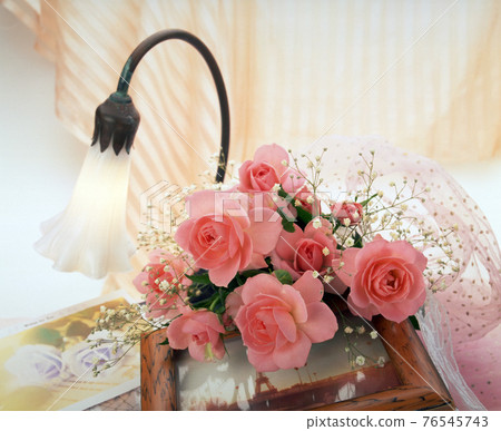Still life with rose flower decoration and table lamp 76545743