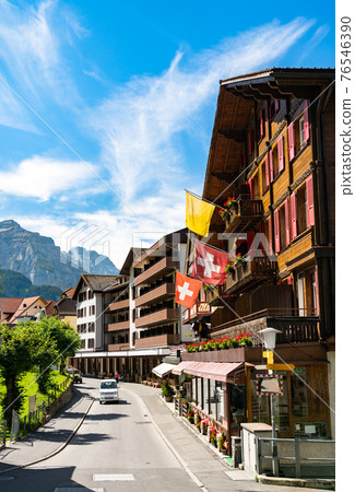 Main street of Wengen with Swiss Flags in Switzerland 76546390