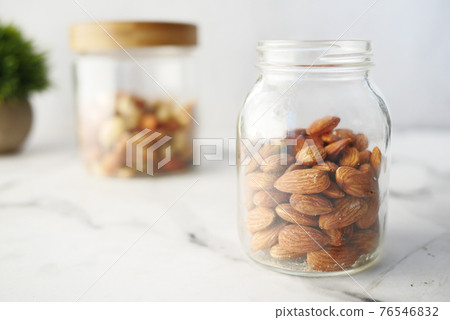 Close up of almond nuts in a bowl on table Close up of almond nuts in a bowl on table 76546832