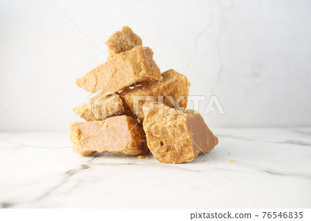 stack of Jaggery traditional cane sugar cube on table stack of Jaggery traditional cane sugar cube on table 76546835