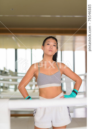 Portrait of Asian woman kick boxer ready for exercise at gym boxing ring Portrait of Asian woman kick boxer ready for exercise at gym boxing ring 76546885