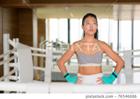 Portrait of Asian woman kick boxer thinking at gym boxing ring Portrait of Asian woman kick boxer thinking at gym boxing ring 76546886