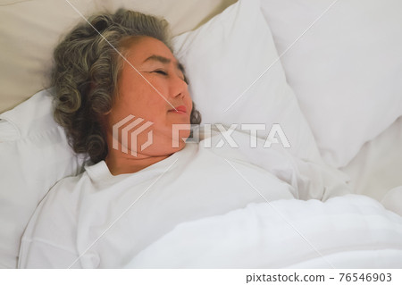 Asian Elderly woman sleep and sweet dream on bed. 76546903