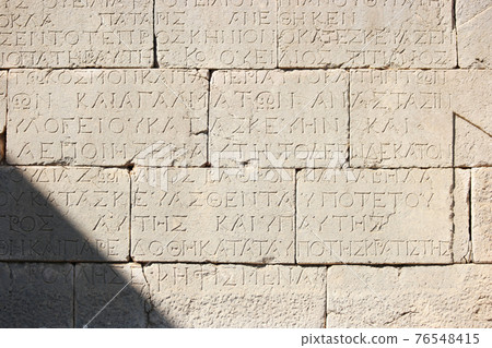 Old stone background with an ancient inscription. Old stone background with an ancient inscription. 76548415