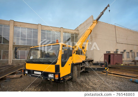 Big Power Mobile Crane on a road and tower crane in construction site Big Power Mobile Crane on a road and tower crane in construction site 76548803