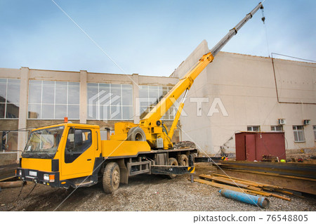 Big Power Mobile Crane on a road and tower crane in construction site 76548805