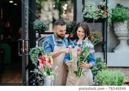 Seller creating fresh new bouquet for birthday, festal, anniversary or date at workplace Seller creating fresh new bouquet for birthday, festal, anniversary or date at workplace 76548846
