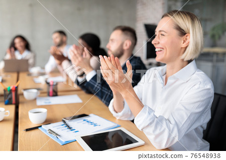 Happy Colleagues Applauding During Corporate Meeting Sitting In Modern Office Happy Colleagues Applauding During Corporate Meeting Sitting In Modern Office 76548938