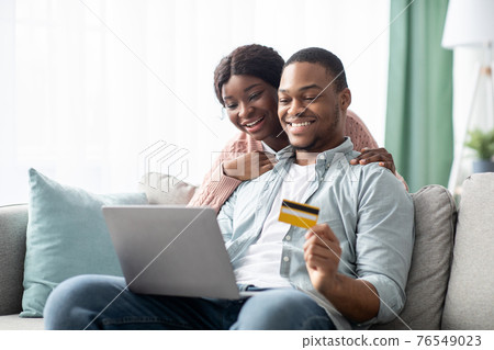 Cheerful young black man and woman shopping online, copy space Cheerful young black man and woman shopping online, copy space 76549023