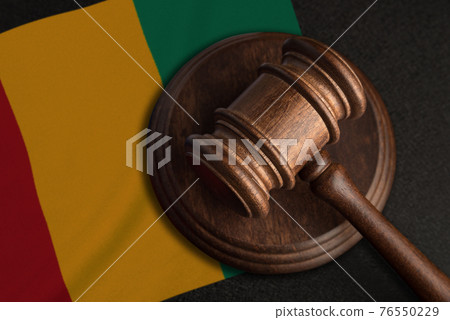 Judge gavel and flag of Guinea. Law and justice in Guinea. Violation of rights and freedoms 76550229