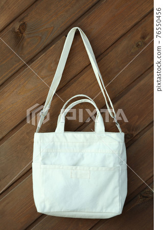 Stylish blank eco bag on wooden background 76550456