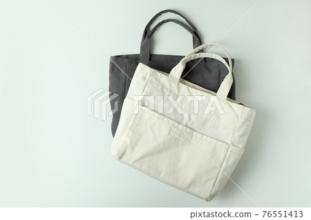 Blank stylish eco bags on white background 76551413