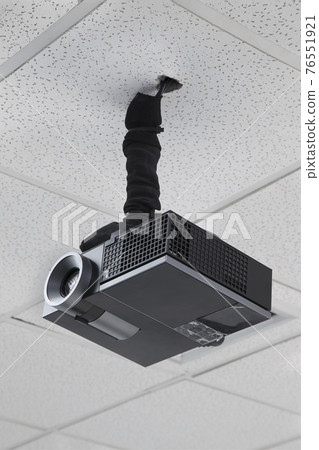 A black overhead projector on ceiling indoors. 76551921