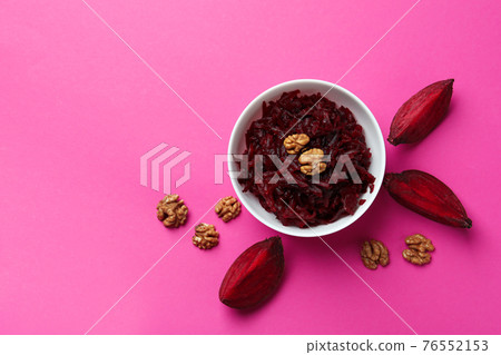 Fresh beet salad and walnut on pink background, top view Fresh beet salad and walnut on pink background, top view 76552153