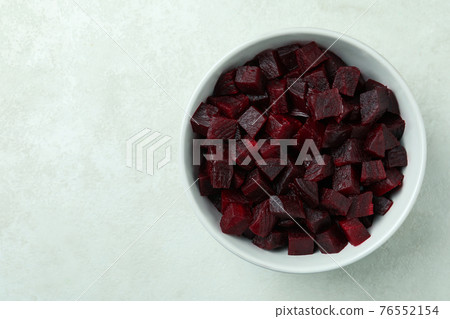 Bowl with fresh beet salad on white textured background 76552154