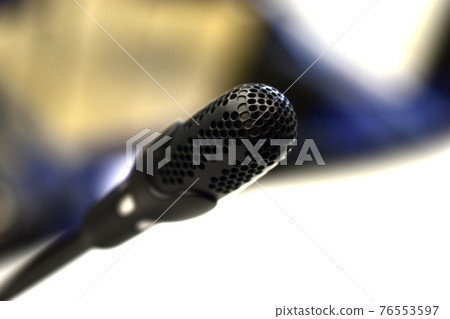 Black microphone close - up in the hall with bokeh 76553597