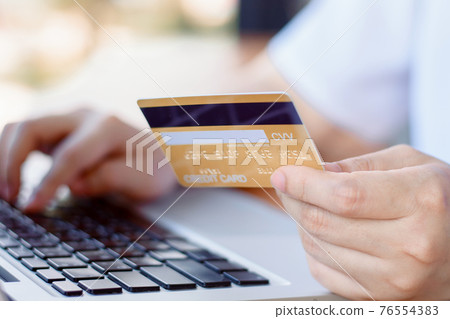 Online Payment . Woman hands holding credit card and using laptop. Online shopping Online Payment . Woman hands holding credit card and using laptop. Online shopping 76554383