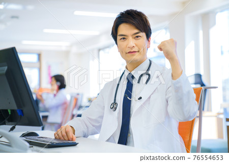 Male doctor doing a guts pose 76554653