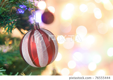 Christmas decoration. Red balls hanging on pine branches Christmas tree garland and ornaments over abstract bokeh background with copy space Christmas decoration. Red balls hanging on pine branches Christmas tree garland and ornaments over abstract bokeh background with copy space 76555444