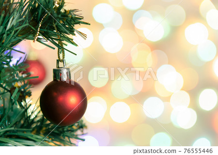 Christmas decoration. Red balls hanging on pine branches Christmas tree garland and ornaments over abstract bokeh background with copy space Christmas decoration. Red balls hanging on pine branches Christmas tree garland and ornaments over abstract bokeh background with copy space 76555446