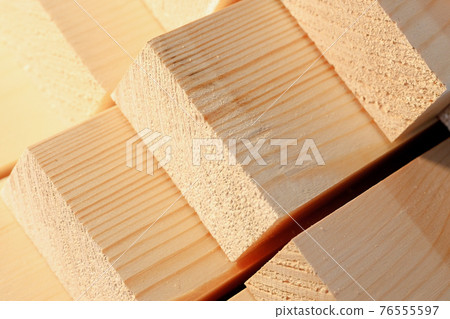 The wooden bars are stacked in a stack. Sawing drying and marketing of wood. Industrial background. 76555597