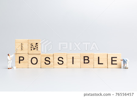 Miniature people worker team on impossible word in wooden alphabet letters Miniature people worker team on impossible word in wooden alphabet letters 76556457
