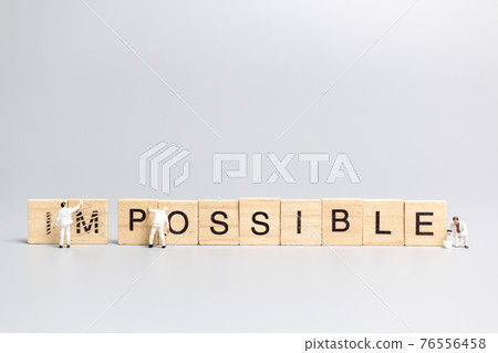 Miniature people worker team on impossible word in wooden alphabet letters Miniature people worker team on impossible word in wooden alphabet letters 76556458