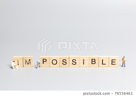 Miniature people worker team on impossible word in wooden alphabet letters Miniature people worker team on impossible word in wooden alphabet letters 76556461