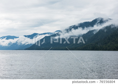 Foggy Teletskoye lake in Altai mountains Foggy Teletskoye lake in Altai mountains 76556804