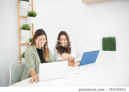 young businesswomen in their company developing their work 76559432