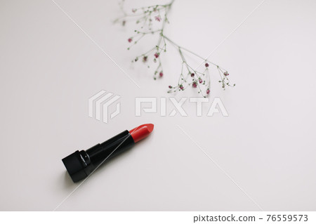 Lipstick with beautiful flowers on white background Lipstick with beautiful flowers on white background 76559573